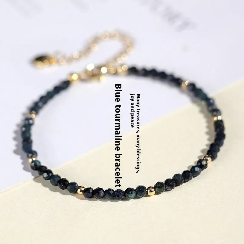 Blue tourmaline bracelet with 3mm beads and spacer bead design on wrist