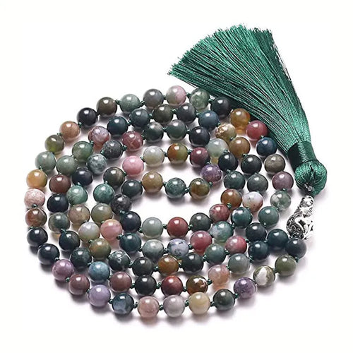 Long agate tassel necklace with geometric stone beads in various colours on a neutral background.