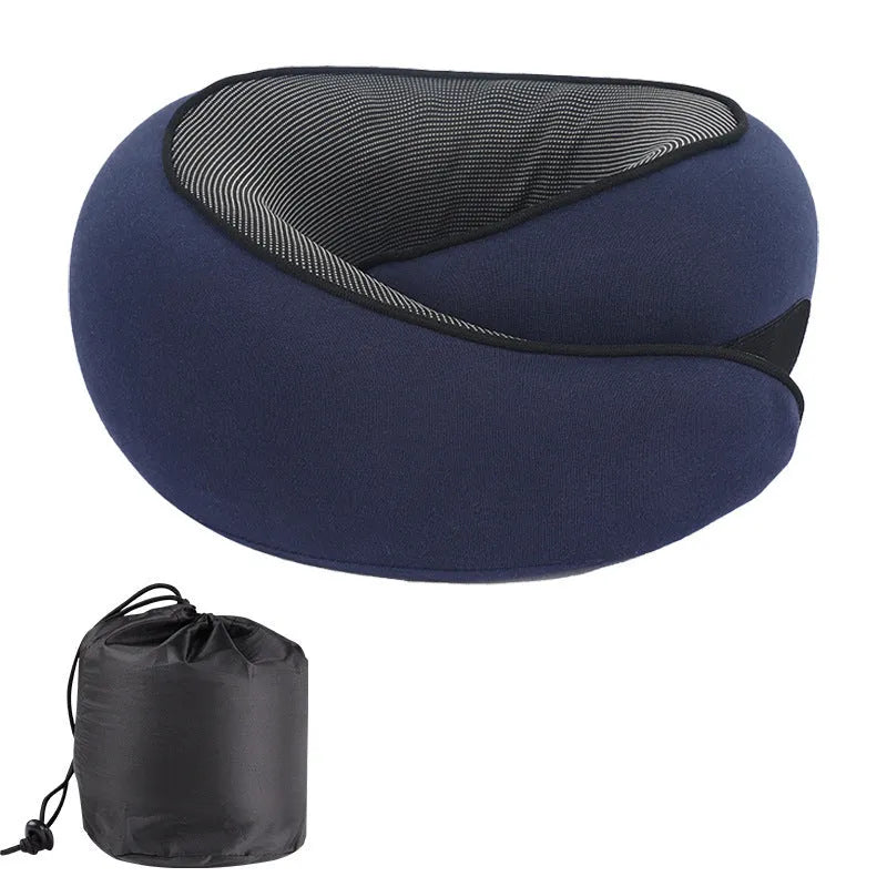 U-shaped grey memory foam travel neck pillow with a black storage bag on a plain background.