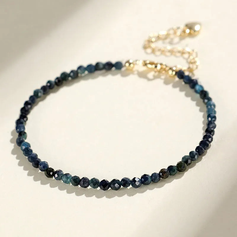 Blue tourmaline bracelet with 3mm beads and spacer bead design on wrist