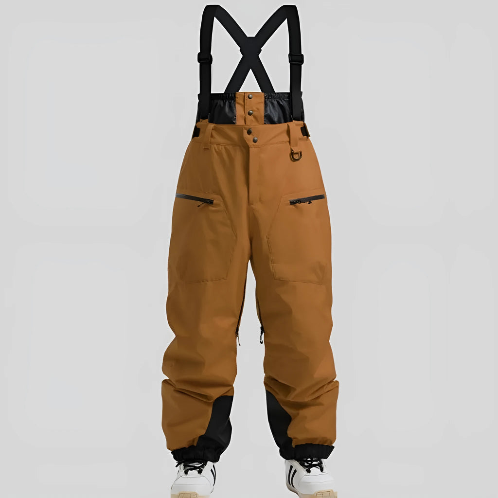 Man wearing black waterproof ski trousers with an adjustable strap on a snowy slope.