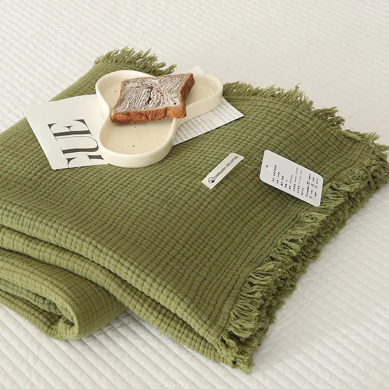Four-layer gauze cotton blanket with tassel detailing in avocado green colour
