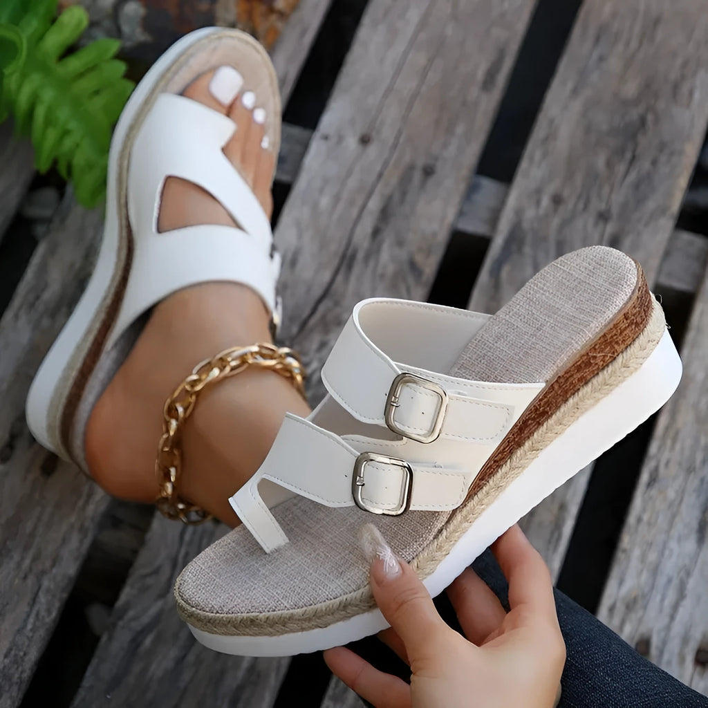 White woven patent leather peep toe wedge sandals on a rubber sole