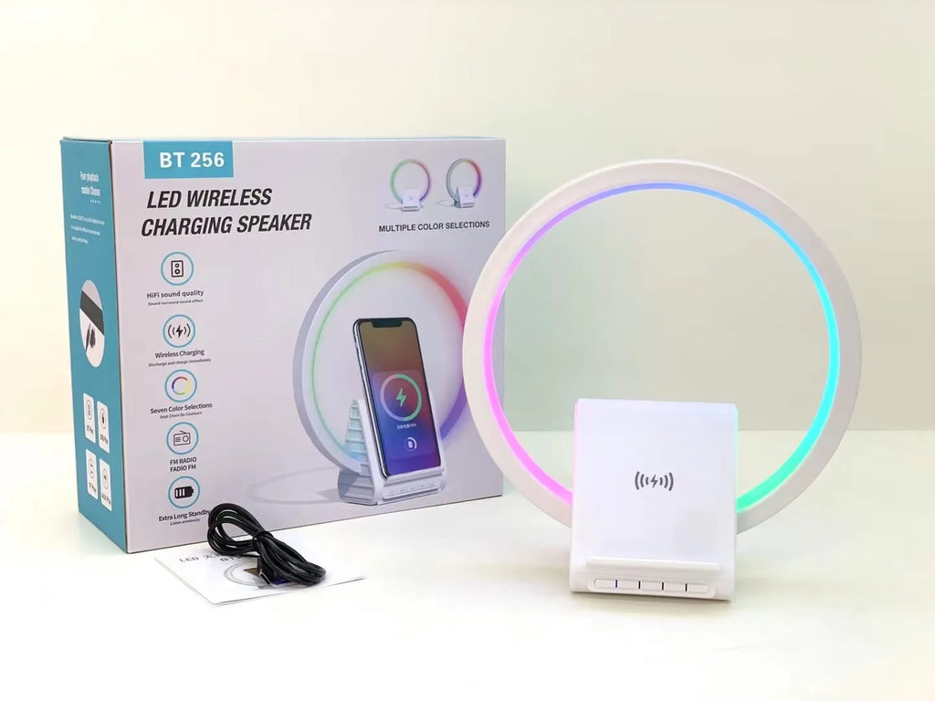 White square Bluetooth speaker with integrated wireless charging pad and ambient LED lighting.