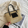 Straw woven women's shoulder bag in black with sewing thread detailing and large capacity design