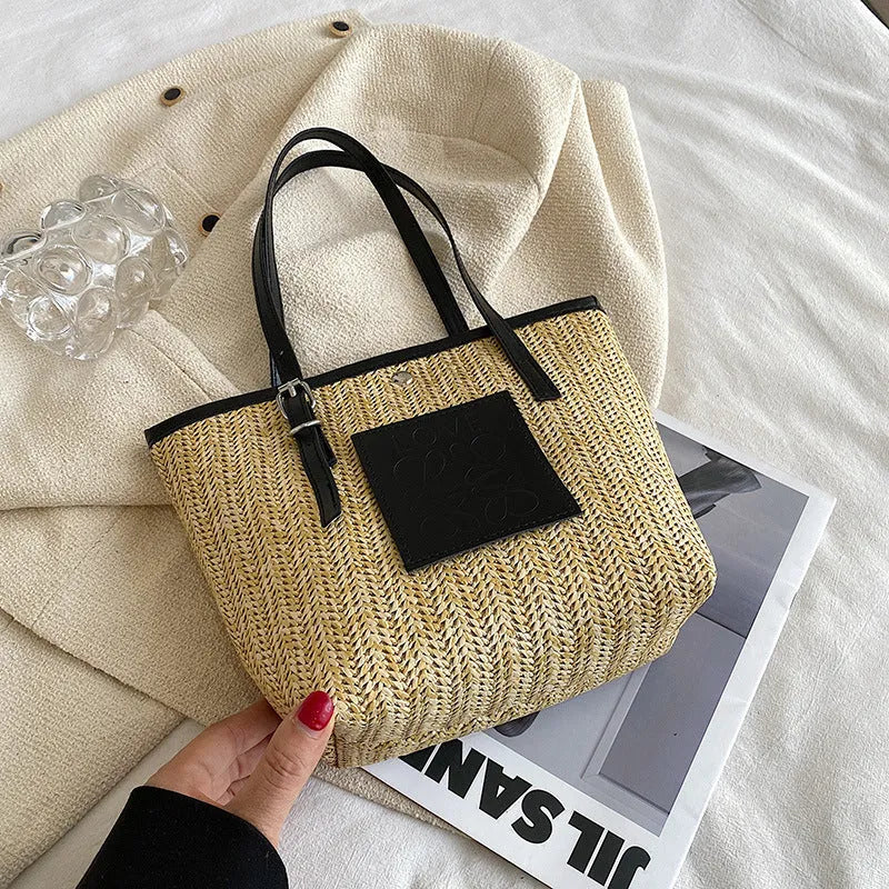 Straw woven women's shoulder bag in black with sewing thread detailing and large capacity design