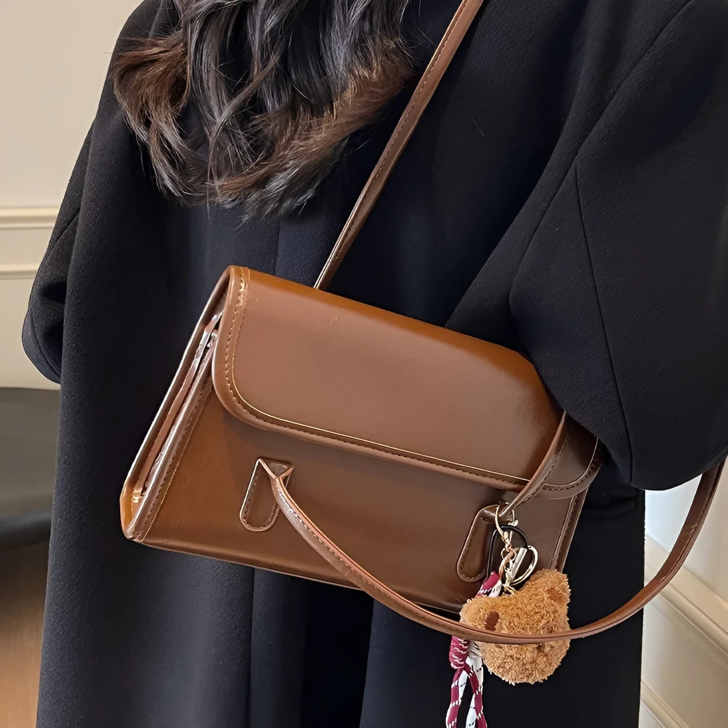 Brown women's PU leather shoulder bag with square shape, pendant detail, and double shoulder straps
