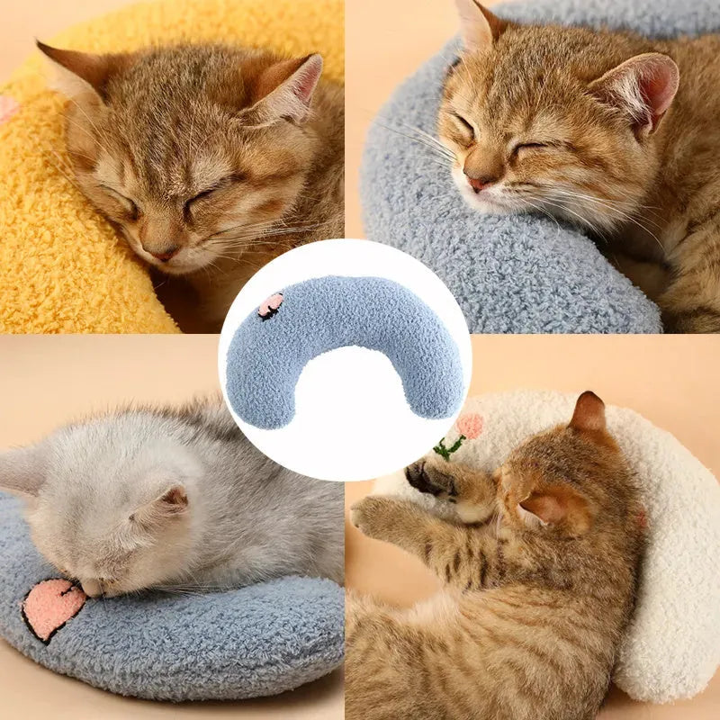 Small blue U-shaped plush pillow for cats or small dogs on a white background.