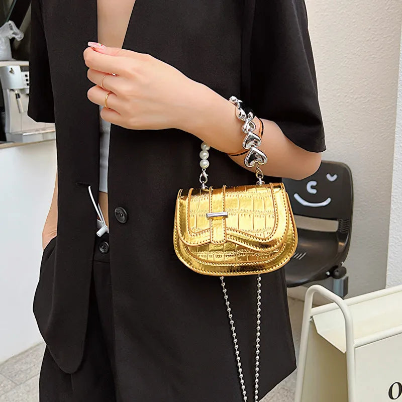 Laser pearl effect mini saddle tote handbag in horizontal square shape with crossbody strap