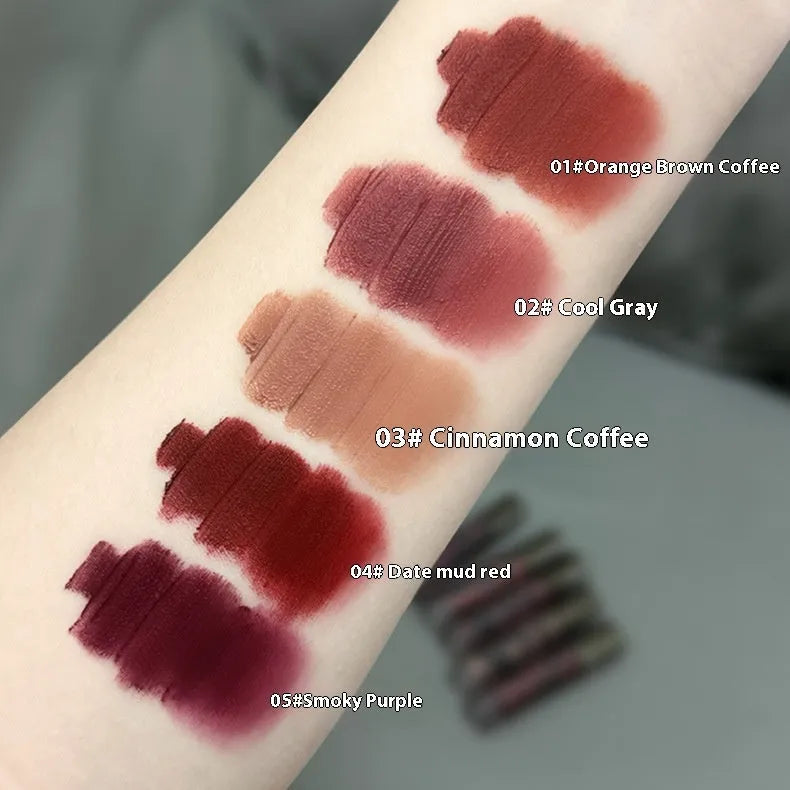 Matte lip mud lipstick tube showing five colour shades including orange brown coffee and cool grey