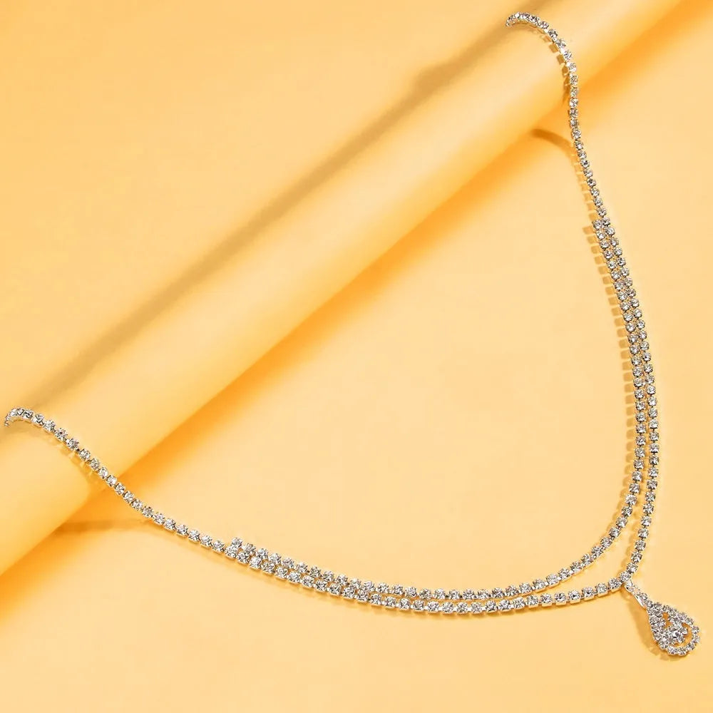 Gold or silver women's waist chain with water drop rhinestone pendant and tassel, 115cm long.
