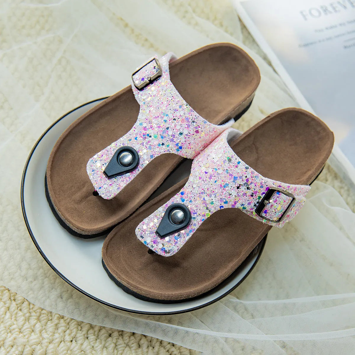 Gold, pink, and silver cork couples flip-flops with artificial leather upper and non-slip sole.