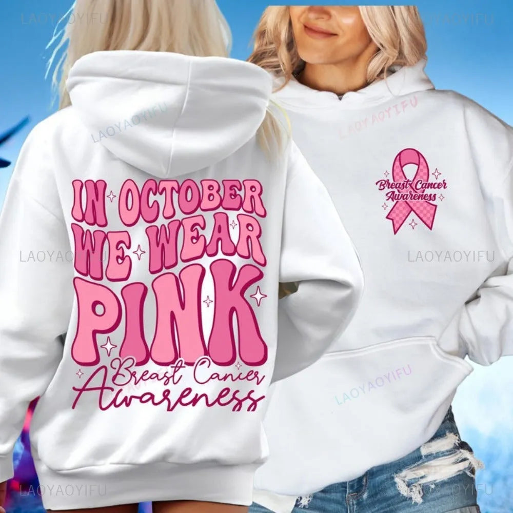 Pink pullover hoodie with a breast cancer awareness slogan, retro graphic, and side seam pockets.