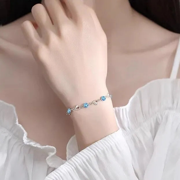 Blue diamond heart pendant necklace and matching bracelet jewellery set on copper