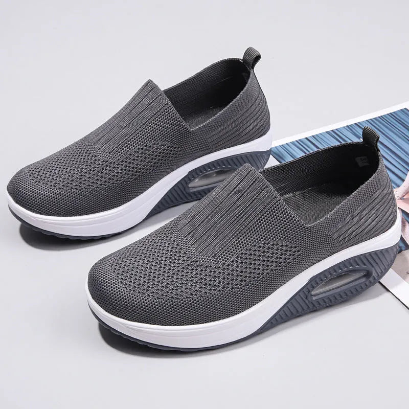 Women's mesh running shoes with air cushion midsole in beige colour on a white background.