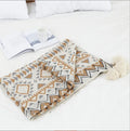 Bohemian-style acrylic sofa blanket with tassel edges in geometric pattern or solid colour options