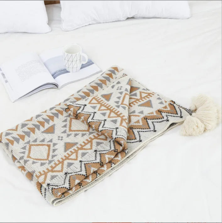 Bohemian-style acrylic sofa blanket with tassel edges in geometric pattern or solid colour options