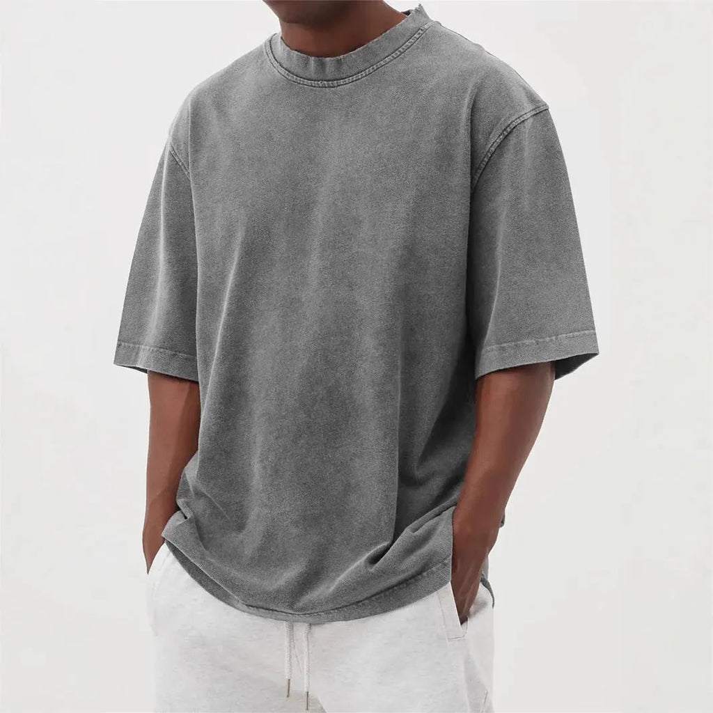 Men's loose-fit stone-washed t-shirt in army green showing distressed texture and pullover style.