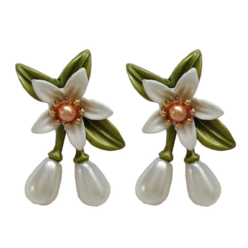 Alloy camellia flower earrings with sterling silver needle and contrasting colours including stud and clip options