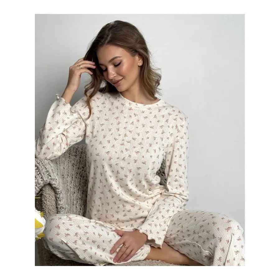 White women's floral print bell sleeve top and wide leg pants casual suit set laid flat
