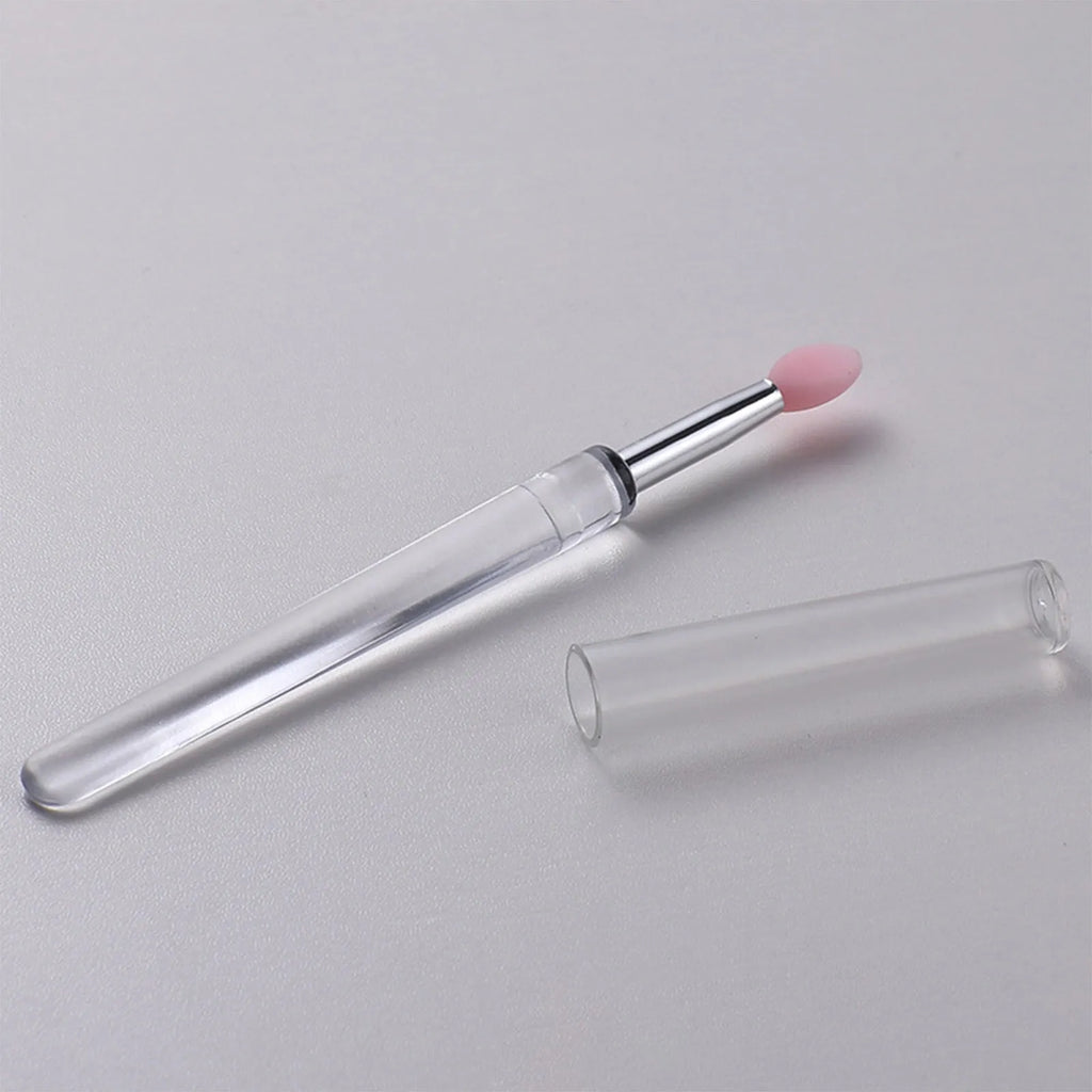 Set of coloured silicone lip brushes with protective caps for applying lipstick and lip gloss.