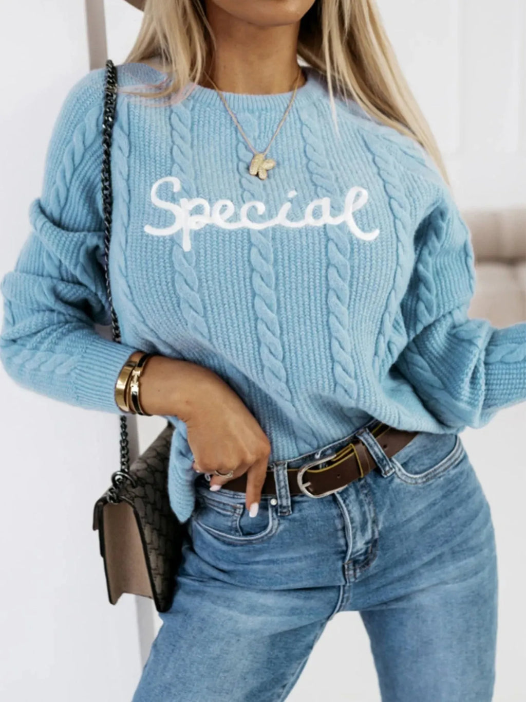 Blue crew neck pullover with embroidered letters design on chest