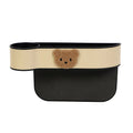 Leather car seat gap storage box with a cartoon bear design hanging between vehicle seats.