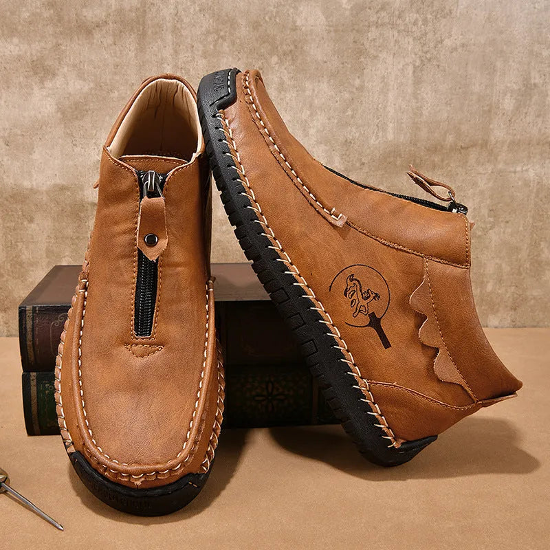 Men's black slip-on leather loafers with round toe and stitching detail on a solid colour background.