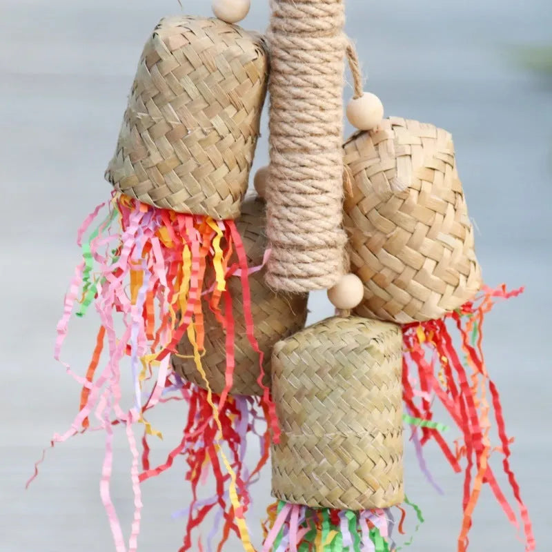 Wooden parrot chew toy with colourful shredded paper hanging from sisal rope