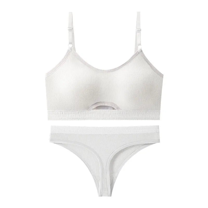 White sports underwear vest with contrast back detail and matching underwear, shown on a hanger.