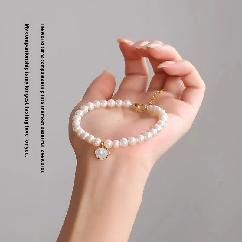 A women's freshwater pearl bracelet with a fan-shaped design, shown in 16cm length with elastic and chain options.