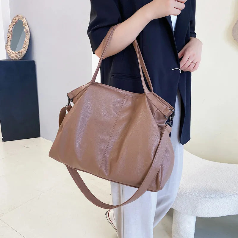 Soft surface messenger bag with adjustable strap showing mobile phone pocket and zipper compartments