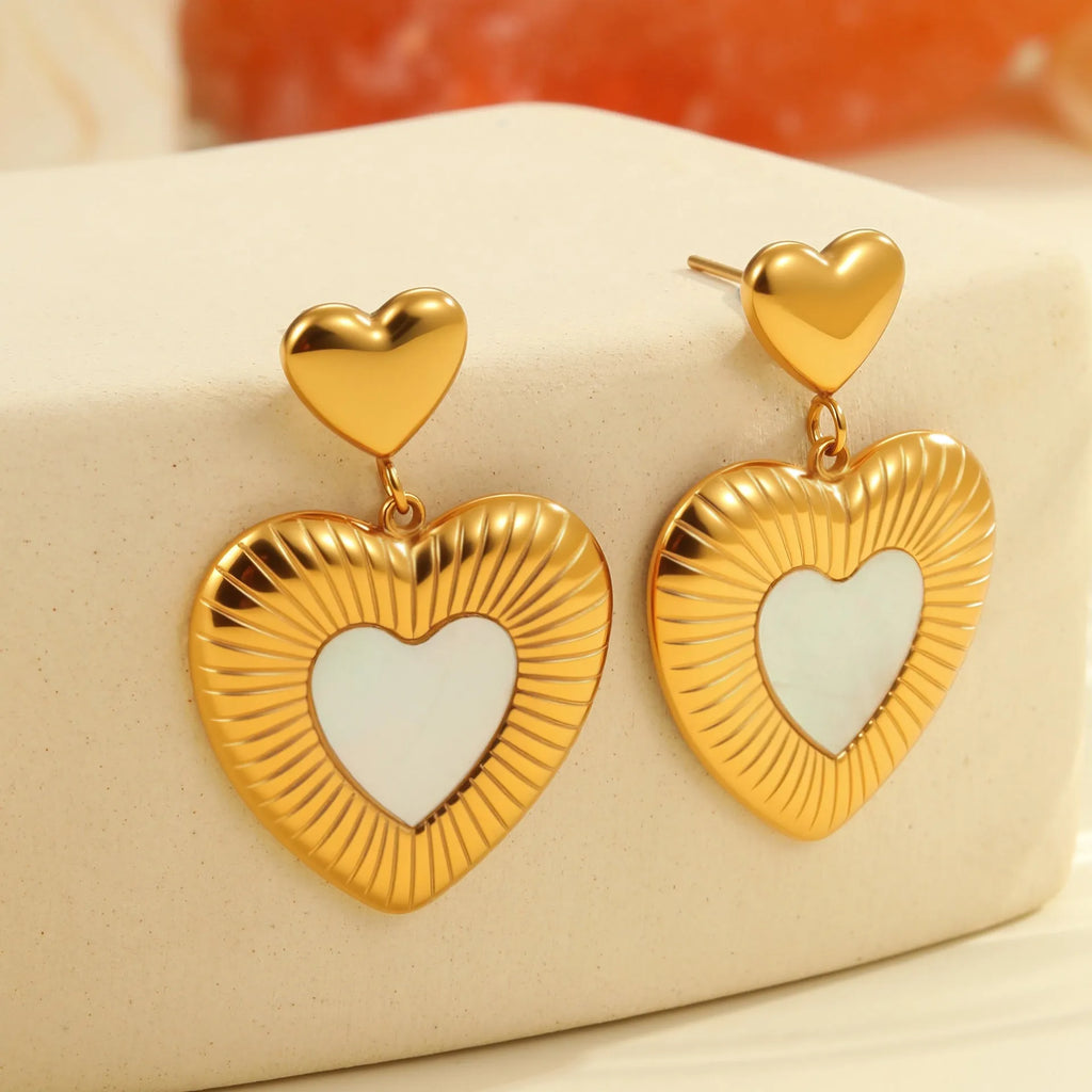 Gold heart-shaped stainless steel stud earrings for women with a love motif.