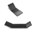 Black mini tri-fold Bluetooth keyboard shown folded and unfolded next to a mobile phone.