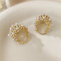 Gold-coloured copper flower basket earrings with rice-shaped bead decoration and pearl inlay detailing