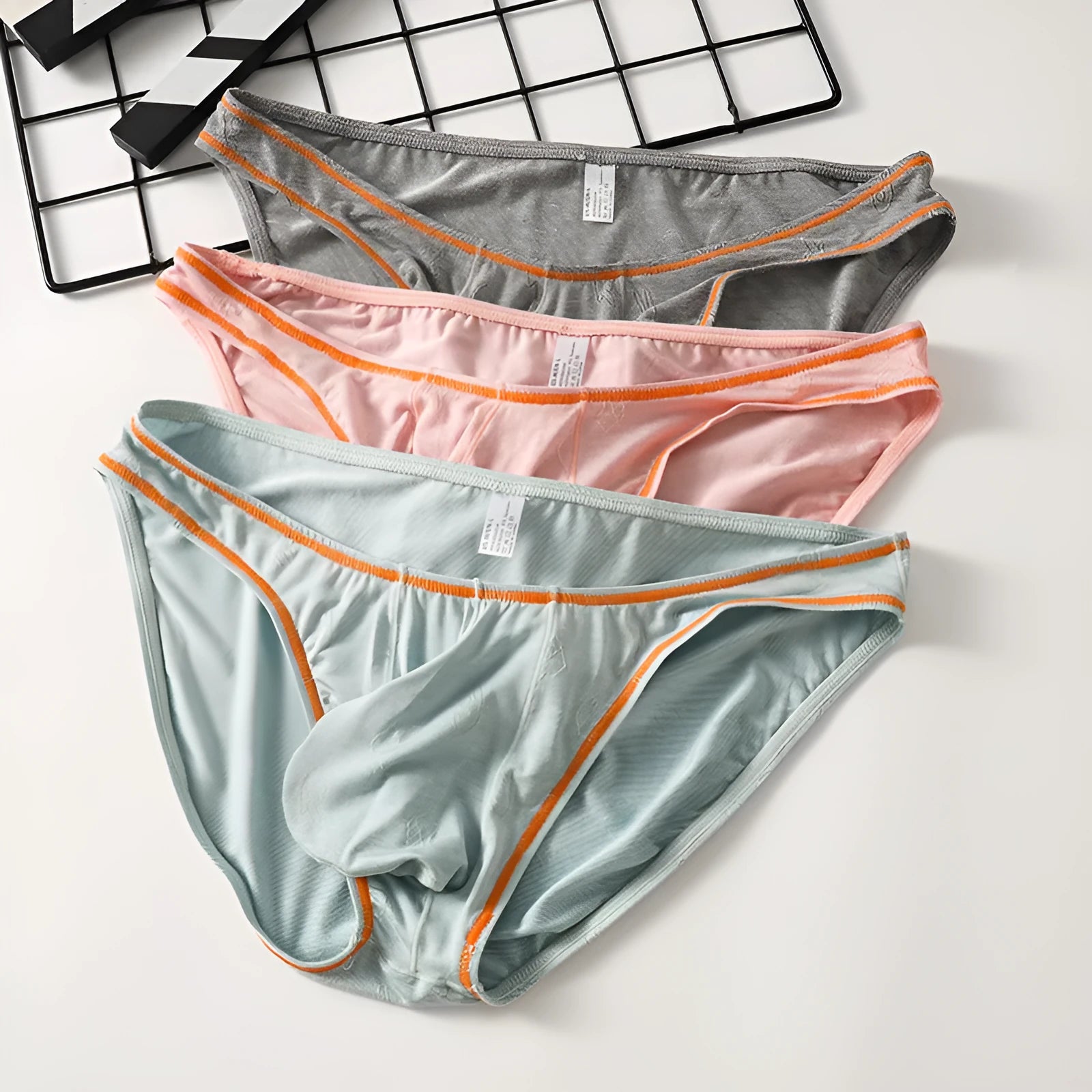 Men's modal ice silk underwear with butt-lift design shown in multiple colours.