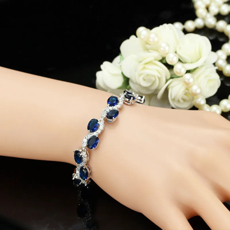 Geometric women's bracelet with zircon stones and gold-electroplated finish on copper base