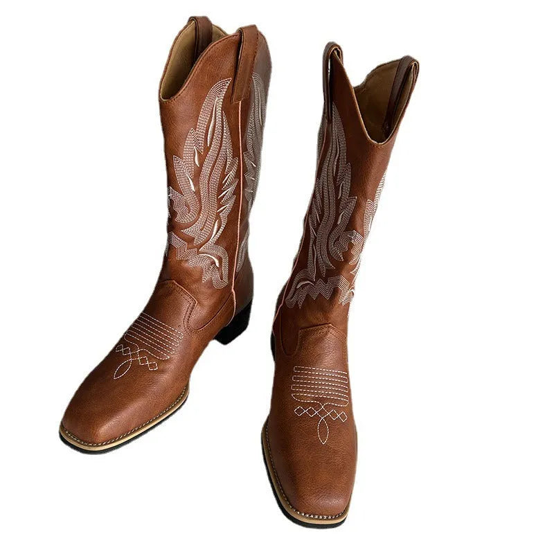 Brown women's mid-calf Martin boots with embroidered detail on the upper and a low square heel.