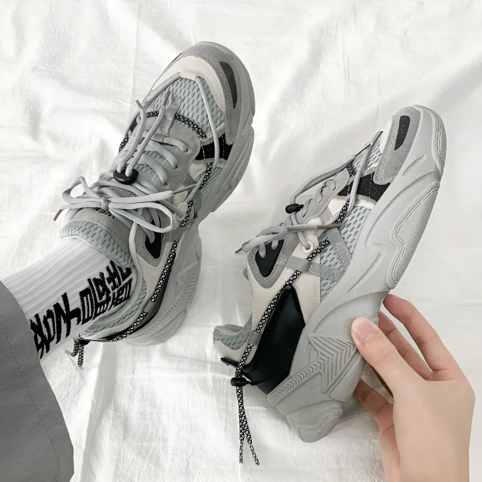 A pair of men's white Korean-style platform sports shoes with a lace-up front.