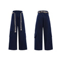 Man wearing dark blue straight-leg cotton jeans with heavy waistband stitching and decorative pocket details