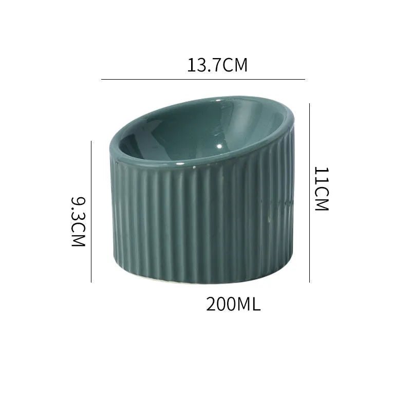 Dark green ceramic elevated cat bowl with tilted, round design for food or water.