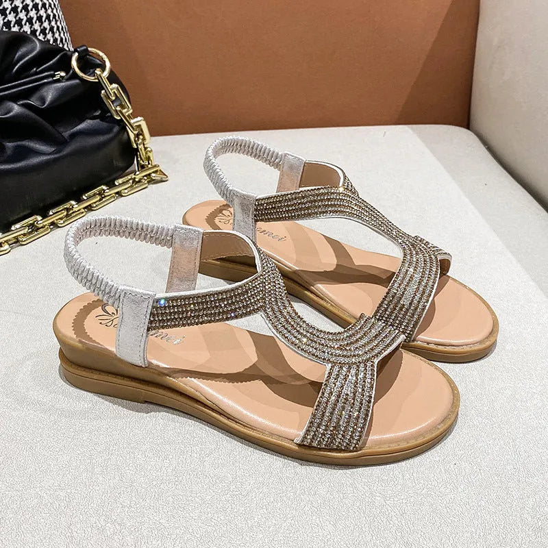 Women's patent leather beach sandals with rhinestone straps and non-slip soles in gold colour.