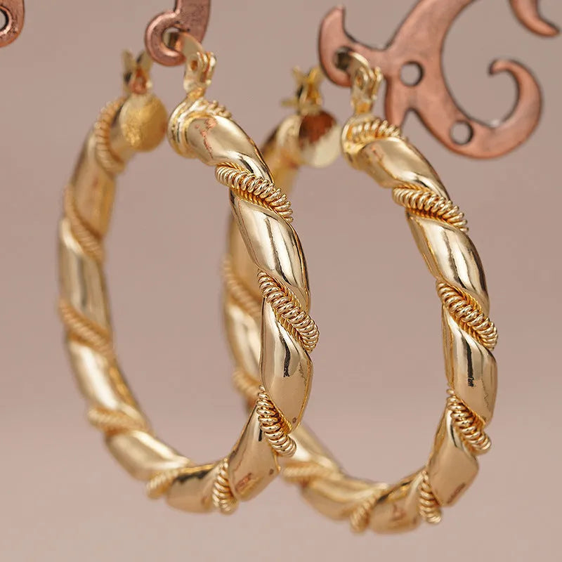 Geometric copper earrings with gold tone finish showing ring and line design elements