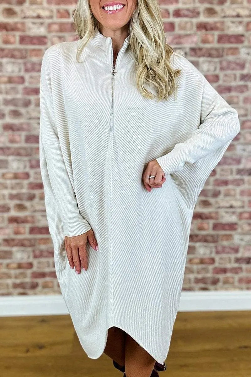 Women's solid colour loose fit knit dress with raglan sleeves on a hanger.