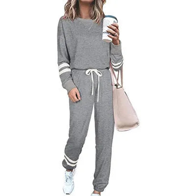Women's plus size casual suit set in loose-fitting design with half-sleeve top and solid colour trousers