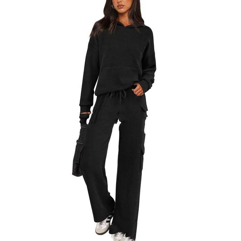 Women's two-piece polyester leisure suit in a solid colour, showing long sleeves and full-length trousers.