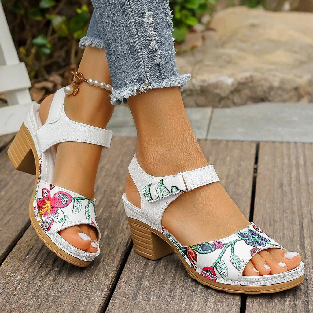 White women's high heel sandals with a Velcro strap buckle and rubber sole.