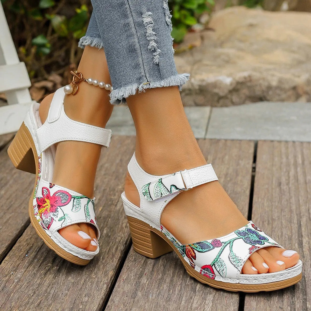 White women's high heel sandals with a Velcro strap buckle and rubber sole.