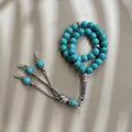 Sky blue natural stone bead Muslim prayer bracelet with 8mm spherical beads on a cord.