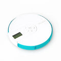 Seven-compartment alarm clock pill dispenser showing medication storage and electronic display